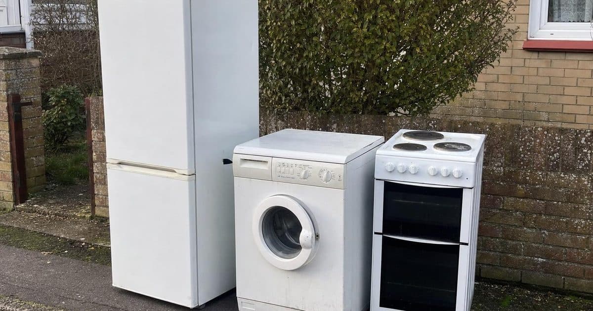 Old white goods including a fridge and washing machine ready for disposal in Fareham
